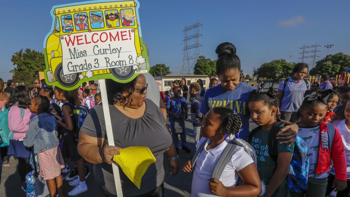 Teacher Sean Curley welcomes her third-grade class on the first day of school at Baldwin Hills Elementary School last week in Los Angeles.
