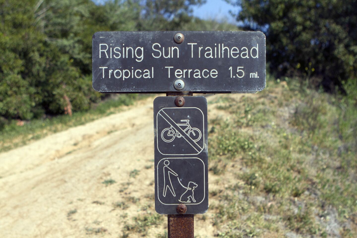 On the TRW Trail, follow signs that lead to the Rising Sun Trail. Cross over a paved road before climbing the ridge on the Rising Sun Trail's dirt pathway.