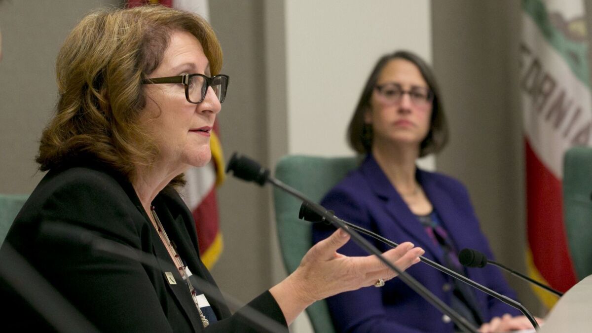 Assemblywoman Eloise Gomez Reyes (D-Grand Terrace), left, asks a question during a hearing about the chamber's policies concerning sexual harassment as Assemblywoman Laura Friedman (D-Glendale) listens.