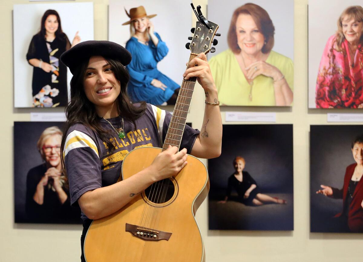 Fullerton resident Kara Hazen plays her guitar and sings in the Fullerton Museum gallery.