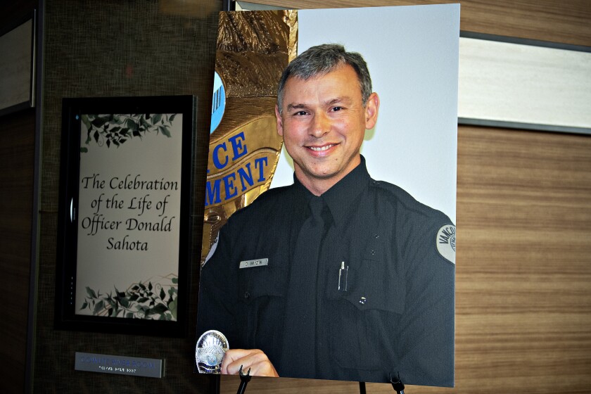 FILE- A portrait of Officer Vancouver Police Department officer Donald Sahota is displayed as he is honored by friends, family and colleagues at ilani Casino Resort near La Center, Wash., on Feb. 8, 2022. Sahota, 52, was mistakenly shot at his home near Battle Ground by a Clark County sheriff during a manhunt for a robbery suspect. Julio Segura, 20, who was being chased when a sheriff’s deputy mistakenly shot and killed off-duty police officer Donald Sahota on Jan. 29, 2022, pleaded not guilty on Tuesday, March 1, 2022, to multiple charges including murder. (Amanda Cowan/The Columbian via AP, File)