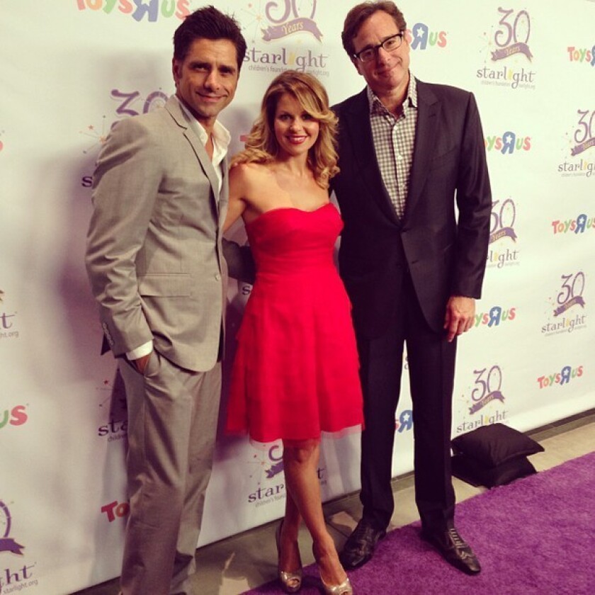Candace Cameron Bure of "Full House" reunites with former costars John Stamos, left, and Bob Saget at a Starlight Foundation charity event.