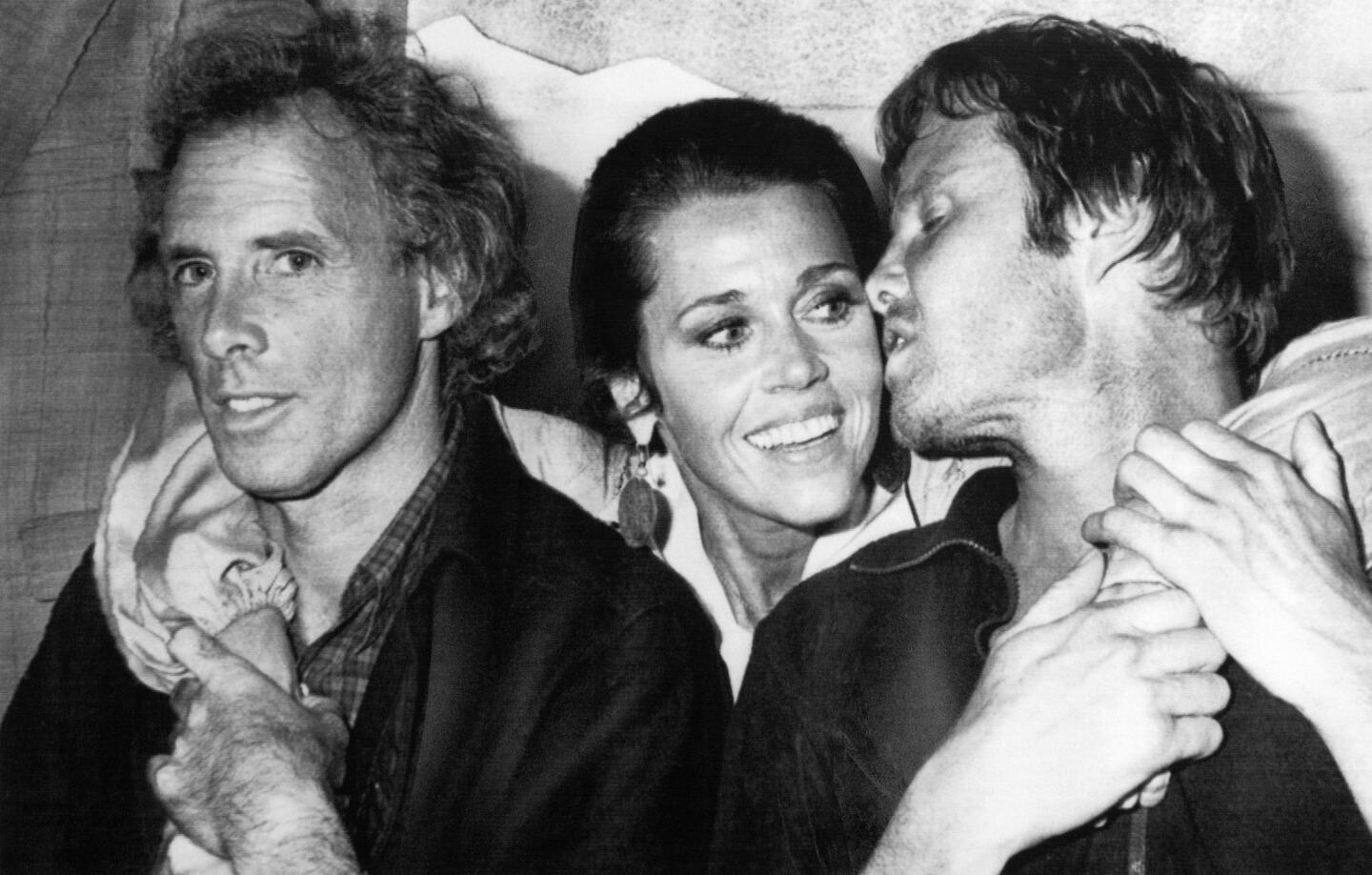 Jon Voight, right, turns to kiss Jane Fonda on May 26, 1978, as they pose with Bruce Dern, left, before the screening of "Coming Home" at the Cannes Film Festival. More: Sign up for our Classic Hollywood newsletter.