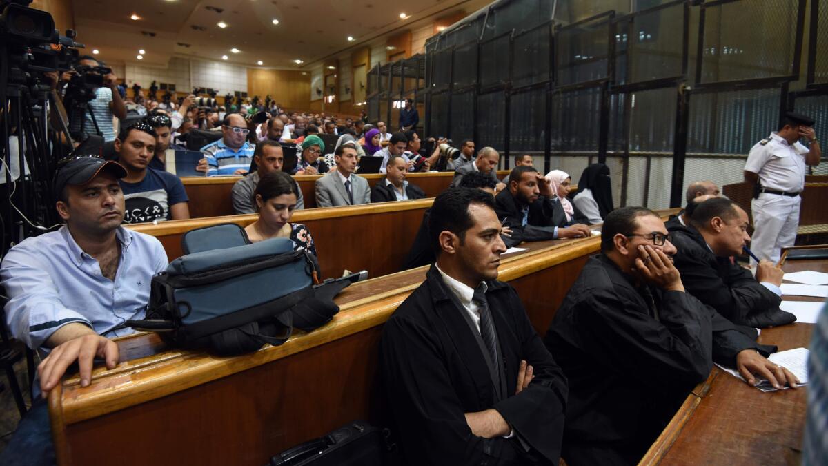 Egyptian police and lawyers attend ousted Islamist President Mohamed Morsi's trial on espionage charges June 18 in Cairo.