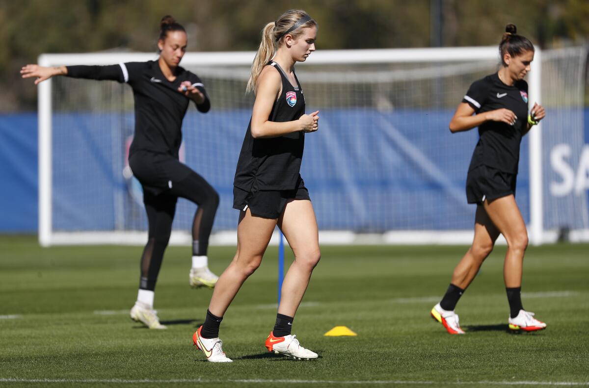 Left to right: Kailen Sheridan, Kelsey Turnbow and Alex Morgan of San Diego Wave FC warm up before Wednesday's practice.