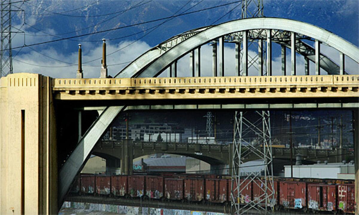 At two-thirds of a mile long, the Sixth Street Viaduct is the largest and longest span along the L.A. River. Known for its two sweeping steel arches and a rather notable curve in the middle, the viaduct is punctuated at either end by decorative pylons with fluted, zigzag designs. Railroad tracks run underneath on both banks of the river. More photos >>>
