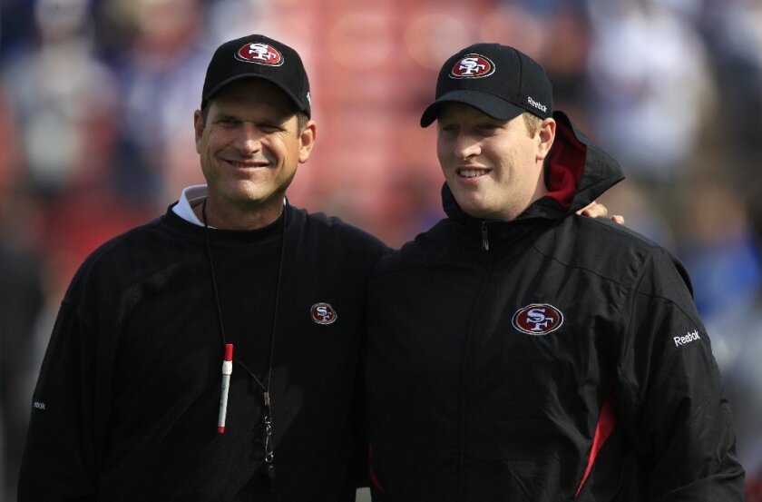San Francisco 49ers head coach Jim Harbaugh, left, and his son Jay are shown before an NFL football game against the New York Giants in 2011.