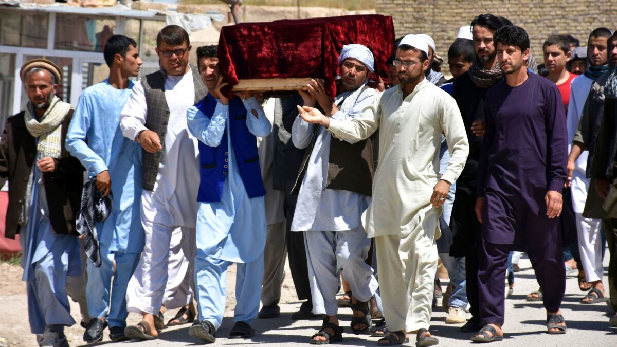 Men carry the coffin of one of the victims of Friday's attack at a military compound in Mazar-i-Sharif province north of Kabul, Afghanistan, on April 22, 2017.