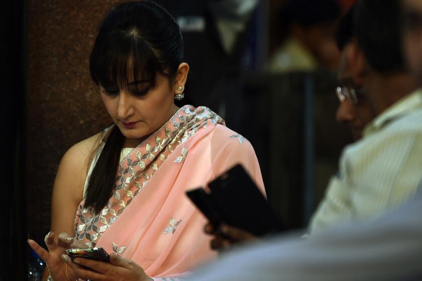 Indian commuters use their smartphones following the introduction of a free wi-fi service in Mumbai's central railway station. This year, the number of smartphone users in India is expected to exceed the size of the entire U.S. population.