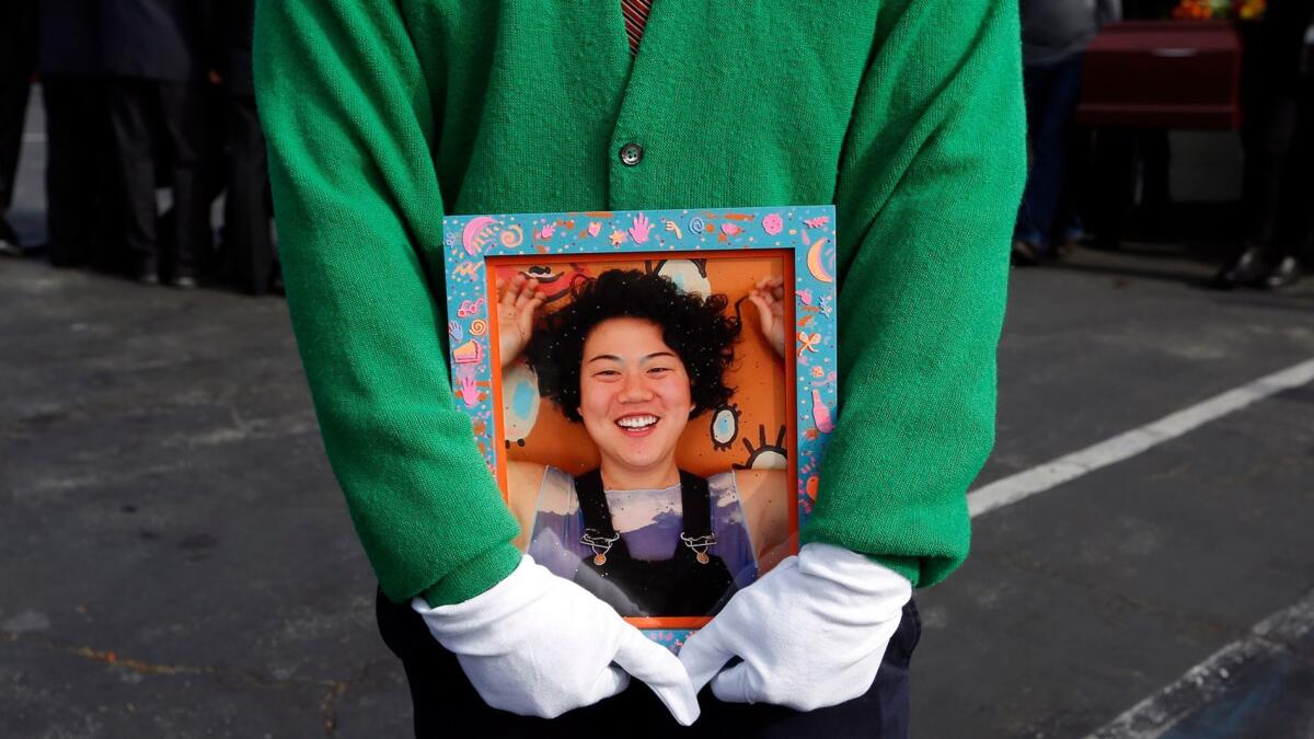 Hoona Jo holds a picture of his sister Ara Jo, who was one of 36 people killed in the Oakland warehouse fire.