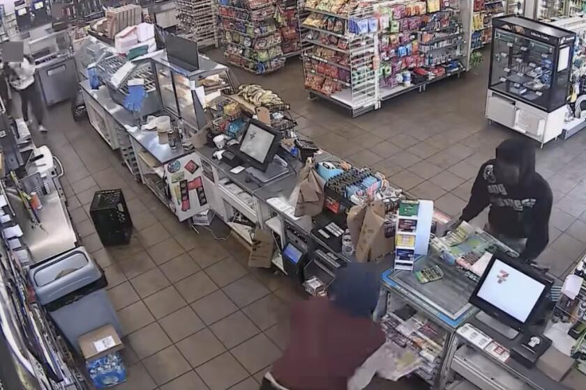 Video screenshot from LAPDHQ Instagram account of suspects taking lottery scratchers at a 7-11.