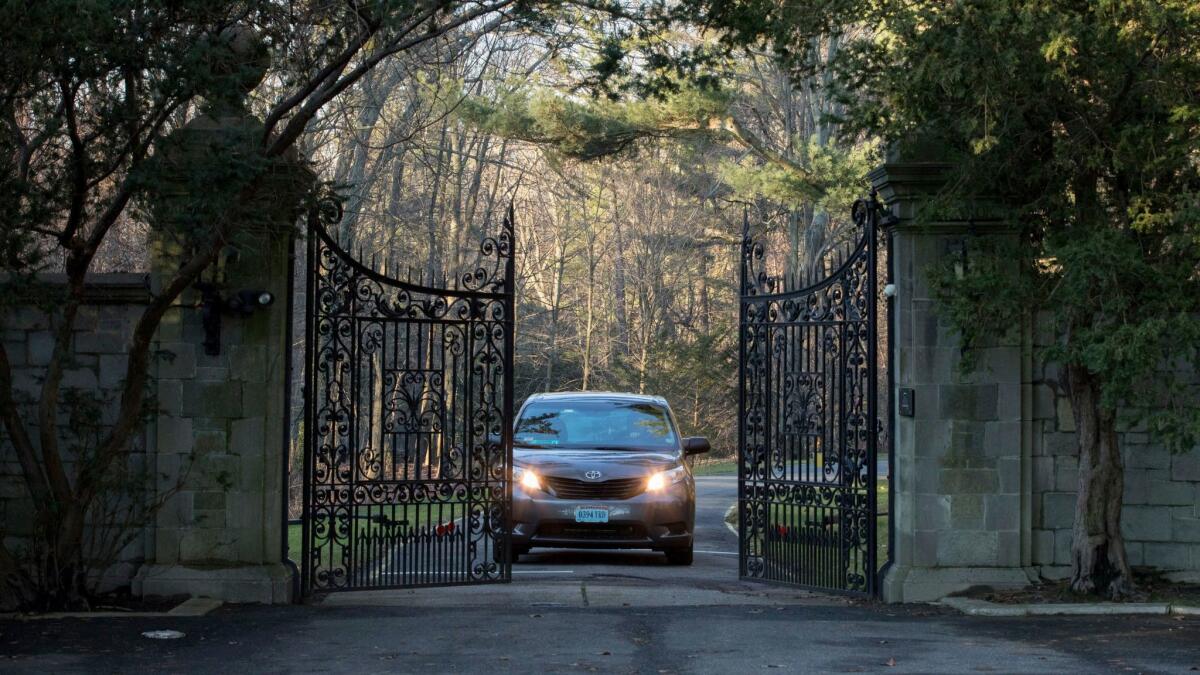 Cars with diplomatic plates drive out of a compound near Glen Cove, N.Y., on Long Island on Friday, Dec. 30, 2016.