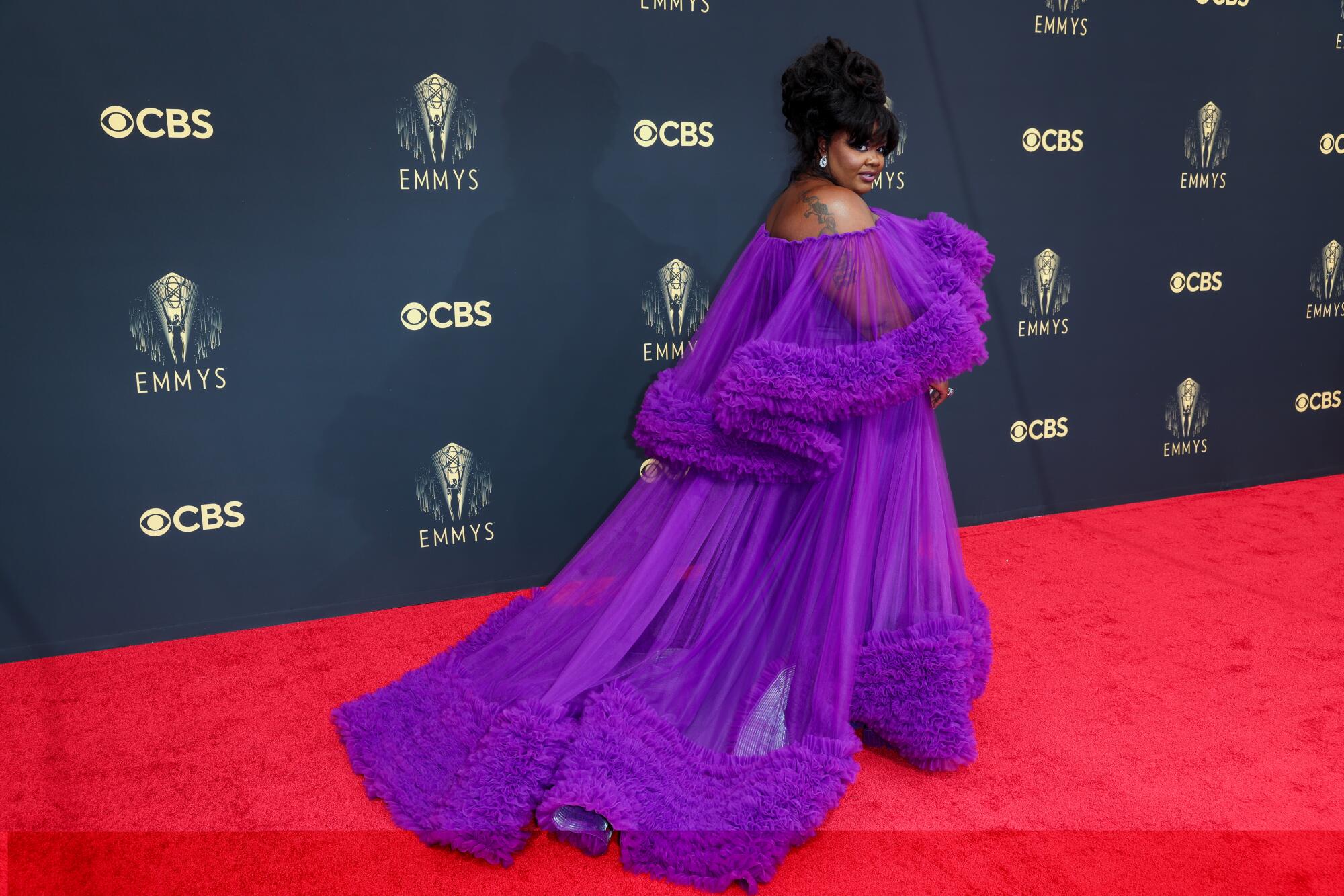 A woman in a bright-purple gown