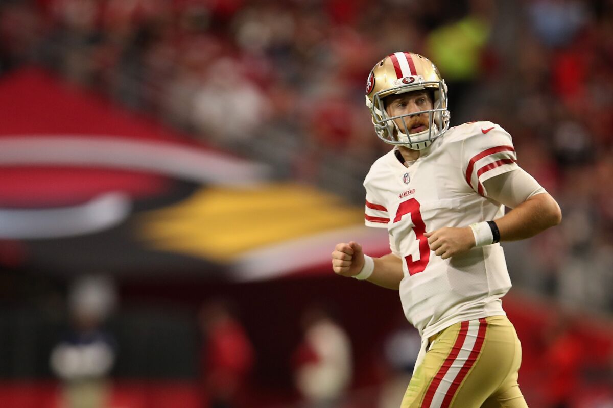 San Francisco quarterback C.J. Beathard runs off the field during a game against the Cardinals on Oct. 28 at State Farm Stadium.