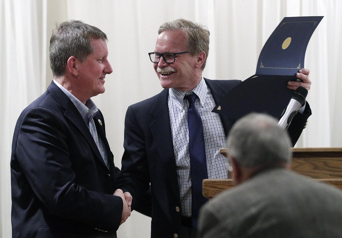 Community Service Award winner for Community Service Joe Radabaugh accepts his award from emcee Chris Erskine.