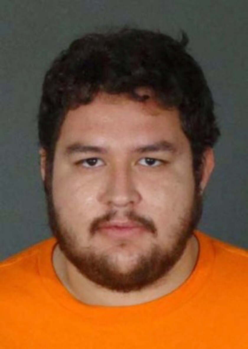 This undated photo released by the FBI shows Omar Alexander Cardenas, an alleged gang member accused of killing a man in a Los Angeles barbershop in 2019. Cardenas has been added to the FBI's "Ten Most Wanted Fugitives" list, authorities said Wednesday, July 20, 2022. The FBI is offering a $100,000 reward for information leading to the arrest of Omar Alexander Cardenas. He is considered armed and extremely dangerous, the FBI said in a statement. (FBI via AP)