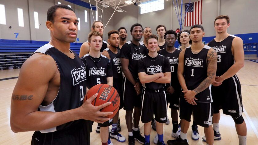 Portrait of Stefawn Payne, left, with his much younger teammates of the California State University San Marcos basketball team at the end of practice.