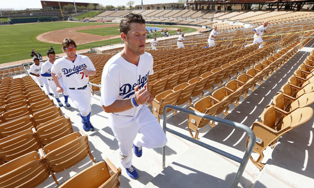 Dodgers starter Clayton Kershaw runs with his teammates at the team's spring training complex in Glendale, Ariz., on Feb. 14. Kershaw might not pitch in the Dodgers' regular-season opener in Australia.