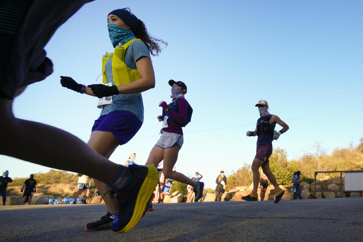 At Daley Ranch in Escondido on Saturday, runners mask up for a 50K and half marathon