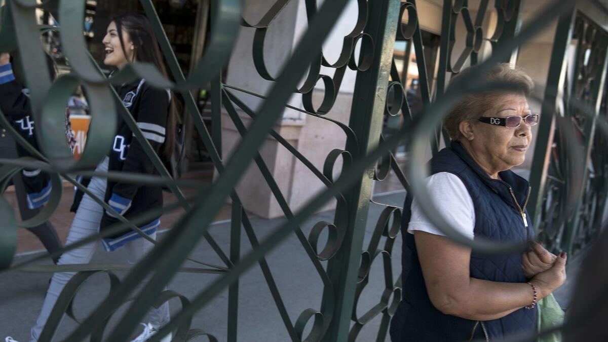Emilia Mata, 64, waits for a bus on Pacific Avenue in Huntington Park. Mata rides three buses to get to her factory job.
