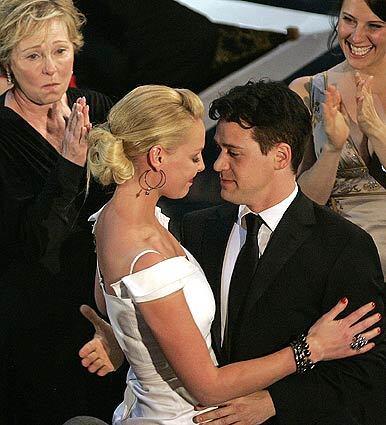 Katherine Heigl gets a hug from friend and "Grey's Anatomy" costar T.R. Knight after her Emmy win on Sunday as best supporting actress in a drama series. The Fox network had to cut away from her when she uttered a profanity in response to her win.