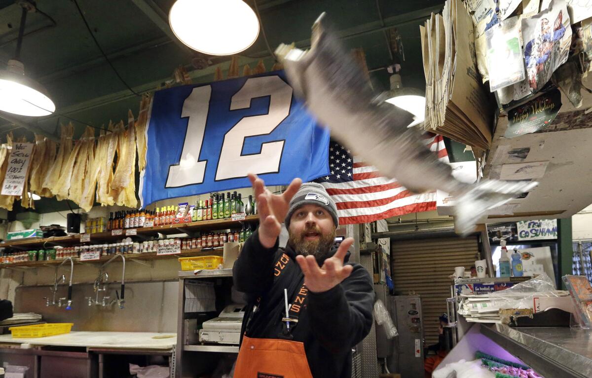 Traditional fish-tossing at Seattle's Pike Place Market: no sign of a slowdown yet because of the minimum wage increase.