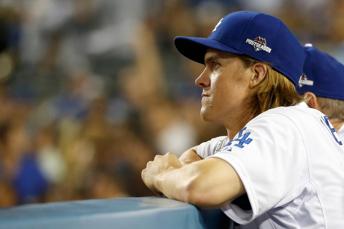 Zack Greinke looks on from the Dodgers dugout after being pulled during the seventh inning of Game 5 of the National League division playoffs on Oct. 15.