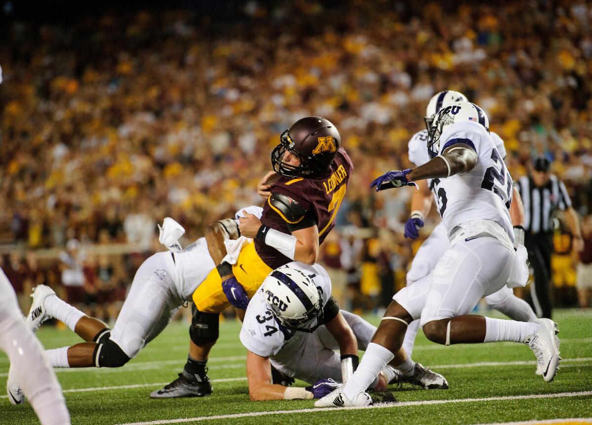 Texas Christian linebacker Mike Freeze (34) helps tackle Minnesota quarterback Mitch Leidner in the season opener, but Freeze is not currently with the team after taking a personal leave of absence.