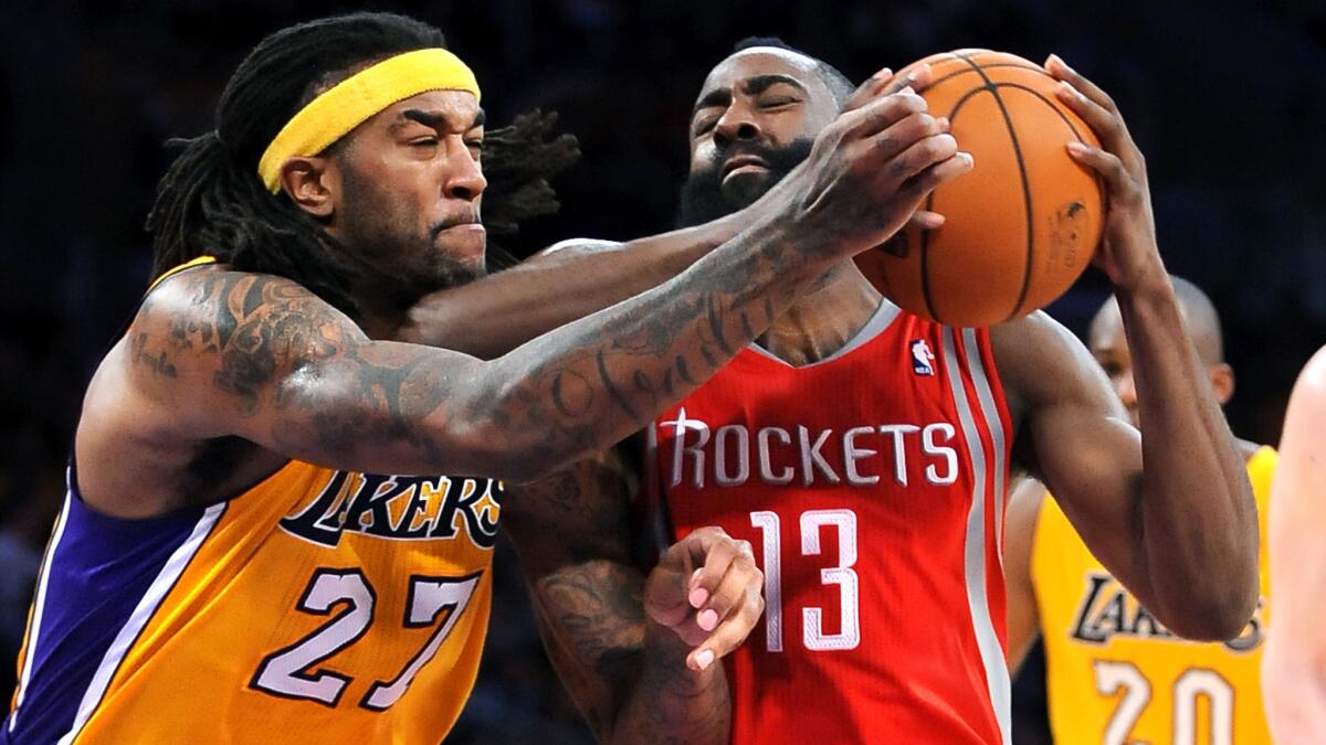 Lakers forward Jordan Hill battles Houston Rockets guard James Harden for the ball during a game at Staples Center this past February. The Lakers will open the regular season at home against the Rockets tonight (Tuesday).