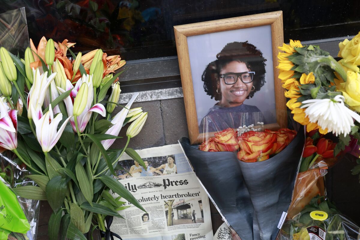 FILE- A memorial honors Sierra Jenkins, an education reporter for The Virginian-Pilot and Daily Press, and others shot outside Chicho's Pizza Backstage in Norfolk, Va., on March 22, 2022, Antoine M. Legrande Jr., 24, has been charged in a March shooting that killed three bystanders in their 20s, including the newspaper reporter, when a fight broke out at closing time outside a Norfolk bar, police announced Wednesday, May 18, 2022. (Kaitlin McKeown/The Virginian-Pilot via AP, File)