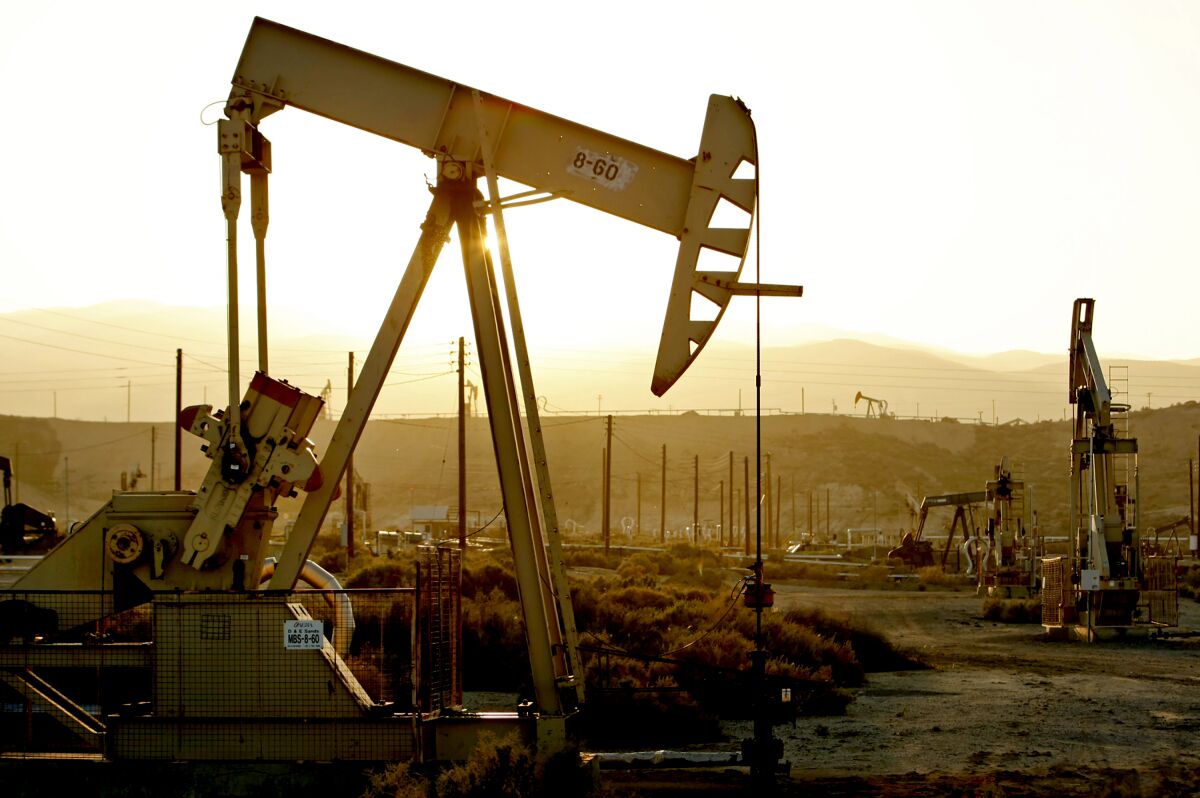 Oil rig pump jacks work the oil fields in Kern County.