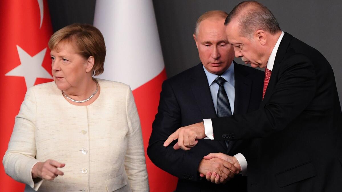 German Chancellor Angela Merkel, Russian President Vladimir Putin and Turkish President Recep Tayyip Erdogan during a conference at a summit called to attempt to find a lasting political solution to Syria's civil war. The summit was in Istanbul, Turkey, on Oct. 27, 2018.