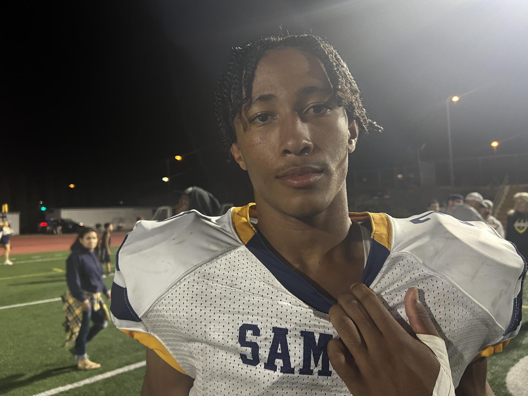 Junior safety Charles Cravings of Santa Monica poses for a photo after a game.