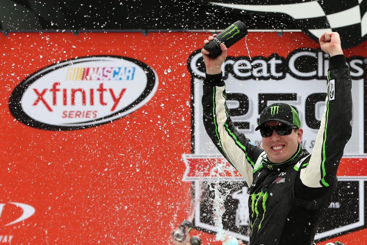 NASCAR driver Kyle Busch celebrates in Victory Lane after winning the Xfinity Series Great Clips 250 at Michigan International Speedway on Saturday.