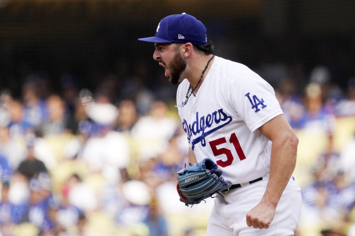 Dodgers relief pitcher Alex Vesia celebrates after San Diego's Austin Nola pops out.