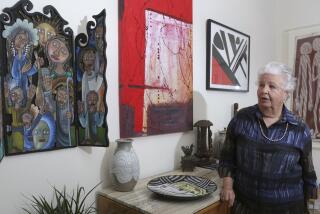 Bea Roberts in her Carlsbad home with some of her many art pieces from around the world. photo by Bill Wechter