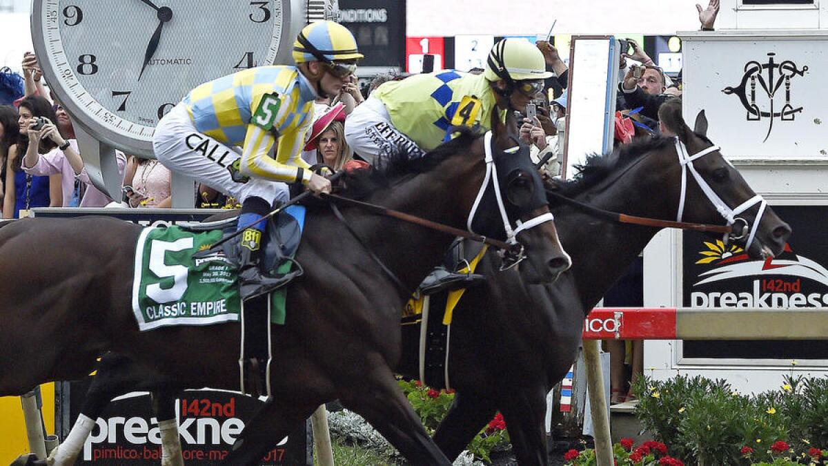 Cloud Computing (2), ridden by Javier Castellano, edges Classic Empire, with Julien Leparoux, to win the 142nd Preakness Stakes.