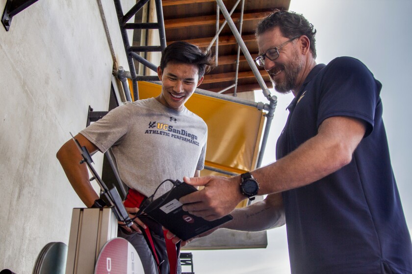 Ryan Ka and Matt Kritz, watch the stats gathered while using the flywheel at UC San Diego