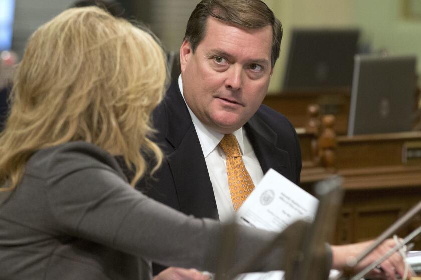 Assemblyman William Brough, R-Dana Point, right, talks with Marie Waldron, R-Escondido, Tuesday, Aug. 30, 2016, in Sacramento, Calif. Lawmakers are working through hundreds of bills as they try to complete their work before the end of the two-year legislative session on Aug. 31. (AP Photo/Rich Pedroncelli)