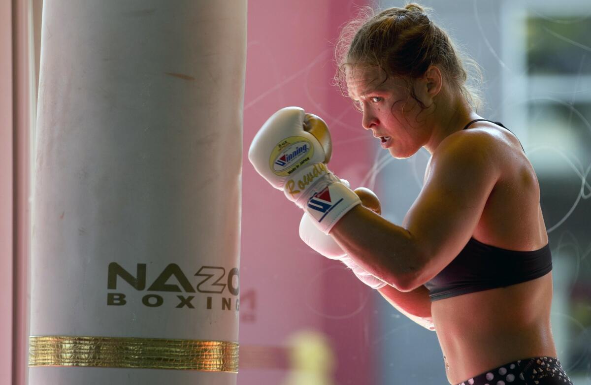 Ronda Rousey works out at Glendale Fighting Club in Glendale in July. The UFC fighter insists she makes more per second than boxer Floyd Mayweather.