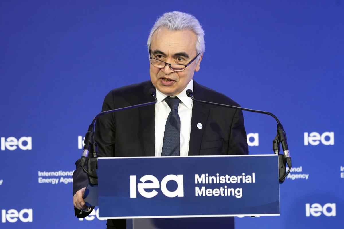 FILE - IEA Executive Director Fatih Birol delivers his speech at the opening session of the International Energy Agency (IEA) ministerial meeting, March 23, 2022 in Paris. Birol and Ukraine's Minister of Energy German Galushchenko have signed today, Tuesday, July 19, 2022, in Warsaw, Poland, the documents for Ukraine to become an Association country of the International Energy Agency, with both sides agreeing that a closer cooperation will help Europe to face what they expect to be a hard winter for the energy sector due to Russia’s aggressive policy. (AP Photo/Michel Euler, File)