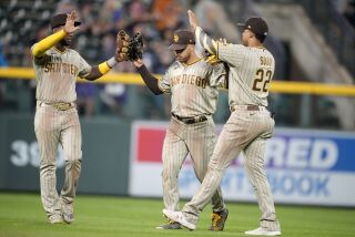From left to right, San Diego Padres left fielder Jurickson Profar, center fielder Trent Grisham and right fielder Juan Soto celebrate after a baseball game against the Colorado Rockies, Saturday, Sept. 24, 2022, in Denver. (AP Photo/David Zalubowski)