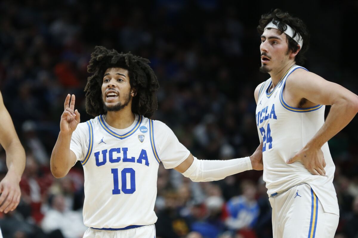 UCLA guards Tyger Campbell (10) and Jaime Jaquez Jr. (24) react during a play.