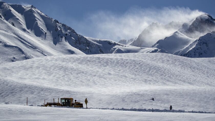 A snow plow clears a road near Highway 395 near Mammoth Lakes, Calif., after heavy snow blanketed the eastern Sierra Nevada mountains during a storm in February.