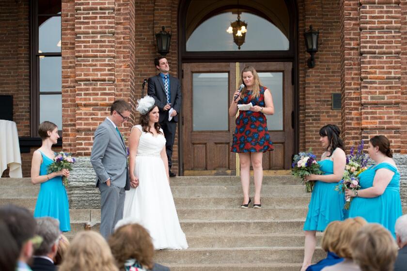 Ann Vardeman reads Justice Anthony M. Kennedy's words during the wedding of Chris Ernt and Jamie Lawler at the Washington County Historic Courthouse in Stillwater, Minn. on July 11, 2015.