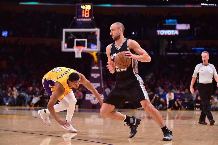 Spurs guard Manu Ginobili gets away from Lakers defender Jordan Clarkson on Friday.