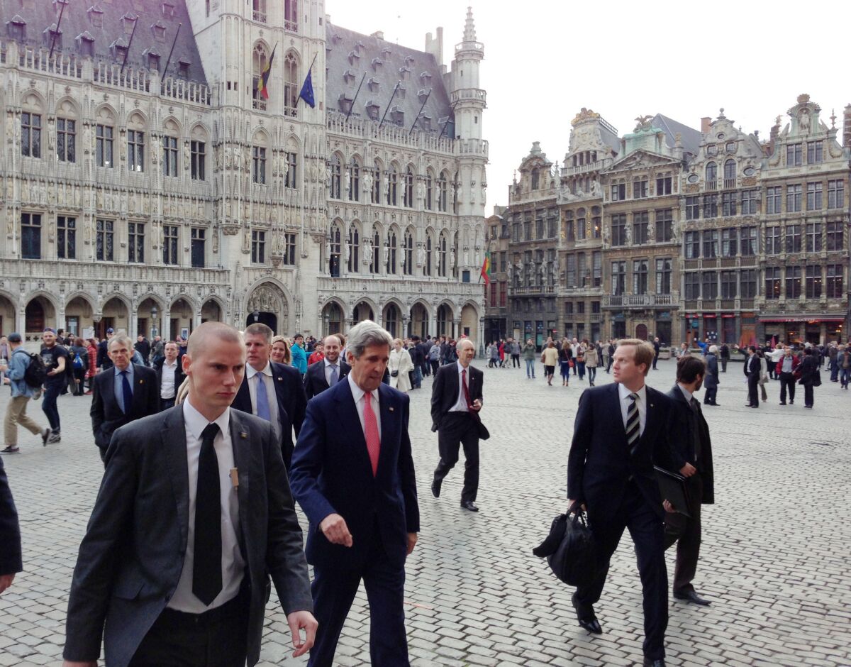 Secretary of State John Kerry and senior staff walk through the Grand Place in Brussels on Tuesday. Kerry began his first NATO foreign ministers meeting by talking about the need to make plans for action against a potential chemical weapons attack in Syria.