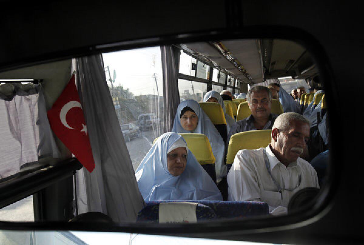 Palestinian pilgrims headed to Mecca, Saudi Arabia, wait on a bus that will take them to the Rafah border crossing between the Gaza Strip and Egypt.