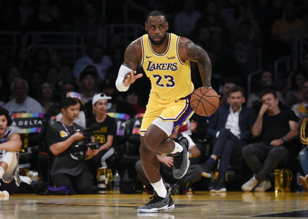 Los Angeles Lakers forward LeBron James moves the ball up court during the first half of an NBA preseason basketball game against the Sacramento Kings in Los Angeles, Thursday, Oct. 4, 2018.