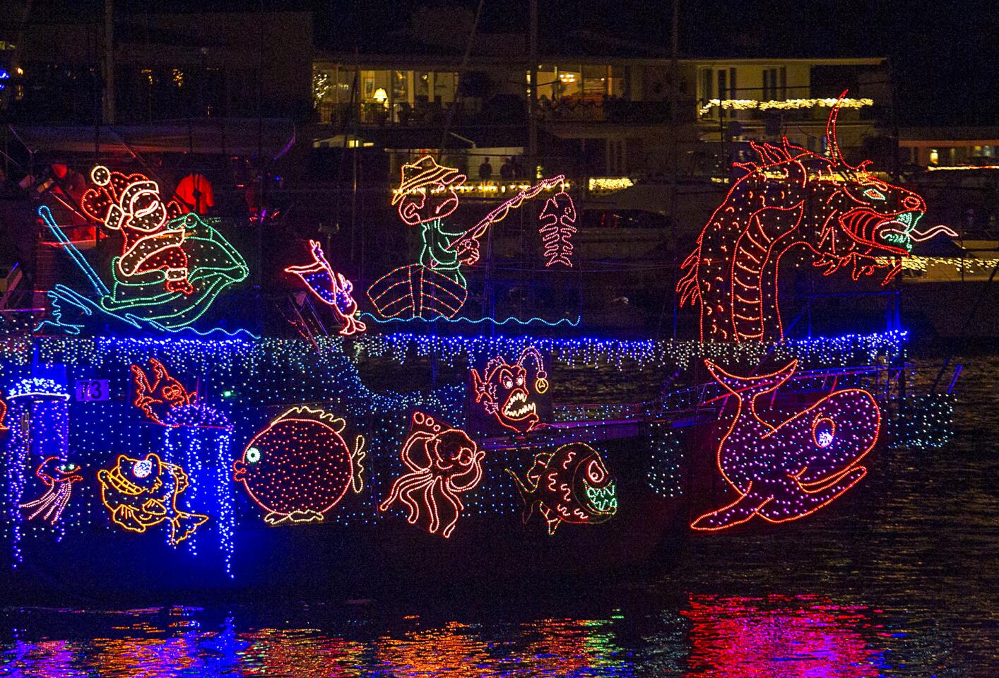 A vessel decked out with scary and fun creatures cruises by on Wednesday during opening night of the Newport Beach Christmas Boat Parade.